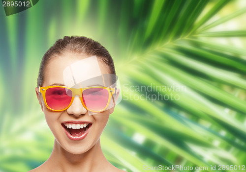 Image of happy teenage girl in pink sunglasses