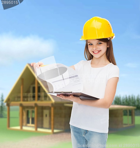 Image of smiling little girl in hardhat with clipboard