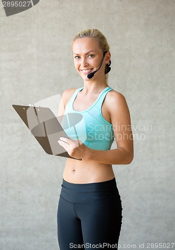 Image of beautiful athletic woman in gym