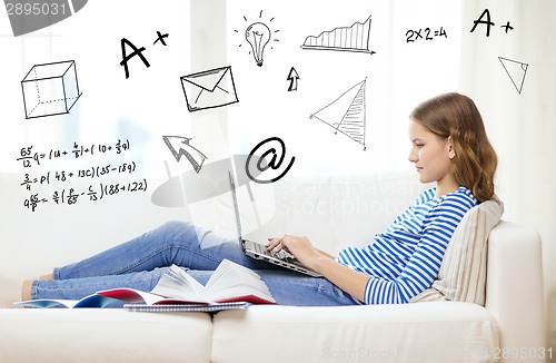 Image of busy teenage girl with laptop computer at home