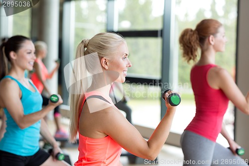 Image of group of women with dumbbells and steppers