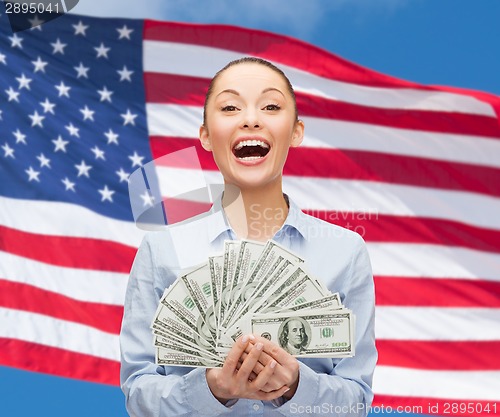 Image of laughing businesswoman with dollar cash money