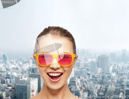 Image of happy teenage girl in pink sunglasses