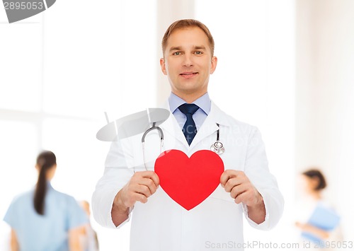 Image of smiling male doctor with red heart and stethoscope