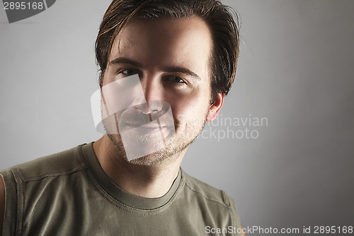 Image of Portrait of an attractive man with green shirt