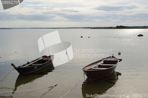 Image of Two old wooden rowing boats by the coast