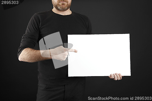 Image of Man holds up poster