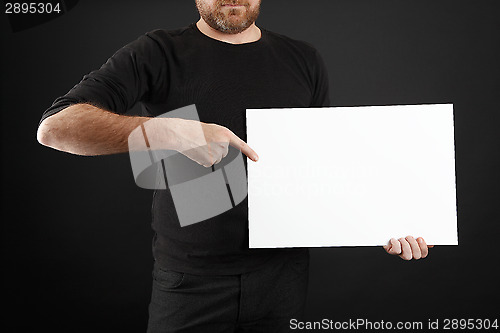 Image of Man holds up poster