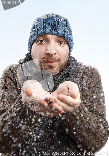 Image of Portrait of an attractive man in the snow