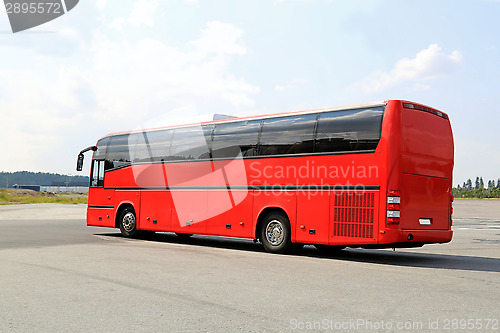 Image of Red Coach Bus Departs for Journey