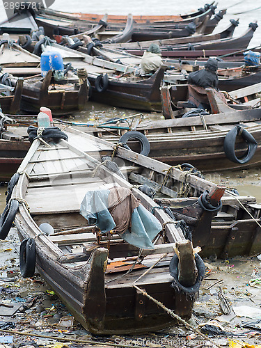 Image of Boats along a polluted seaside in Myanmar