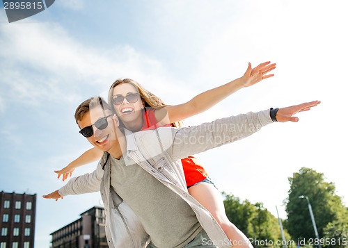 Image of smiling couple having fun in city