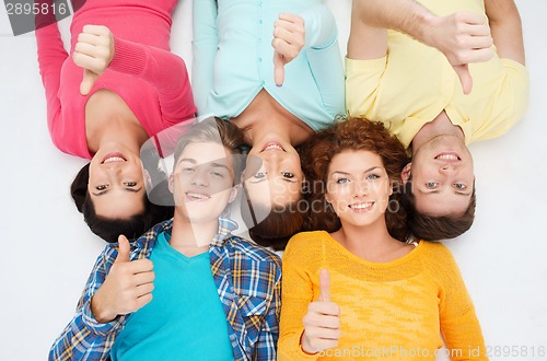 Image of group of smiling teenagers showing thumbs up