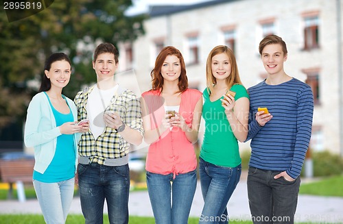 Image of smiling students with smartphones