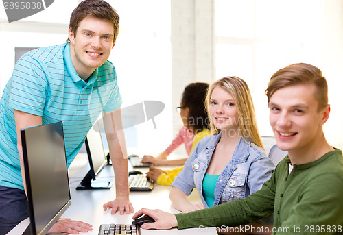 Image of group of smiling students in computer class