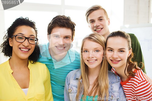 Image of group of smiling people at school or home