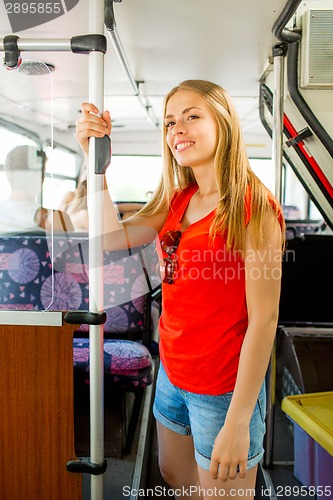 Image of smiling teenage girl going by bus