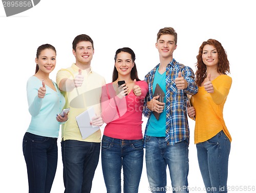 Image of group of teenagers with smartphones and tablet pc