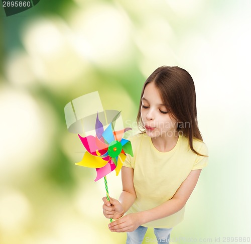 Image of smiling child with colorful windmill toy