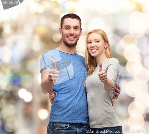 Image of smiling couple showing thumbs up