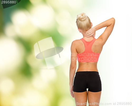 Image of sporty woman touching her neck