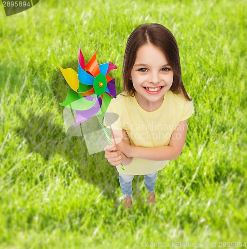 Image of smiling child with colorful windmill toy