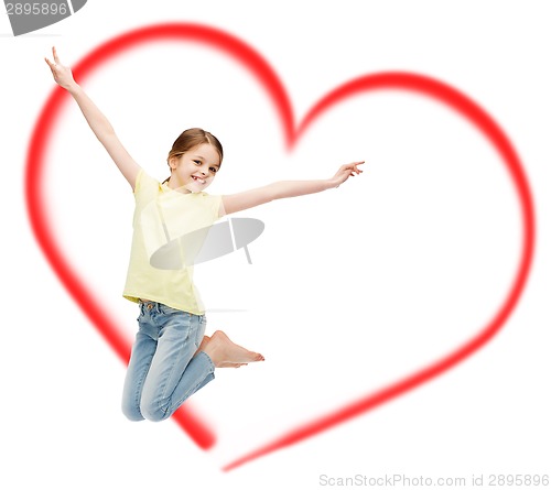 Image of smiling little girl jumping