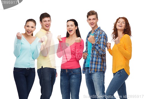 Image of group of smiling teenagers showing triumph gesture