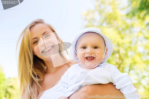Image of happy mother with little baby in park