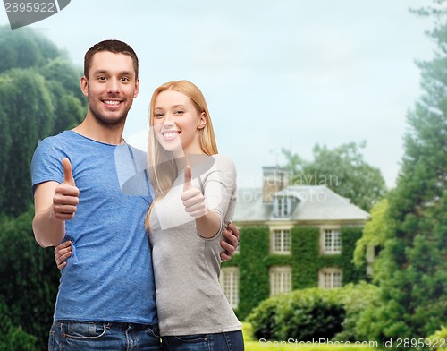 Image of smiling couple showing thumbs up