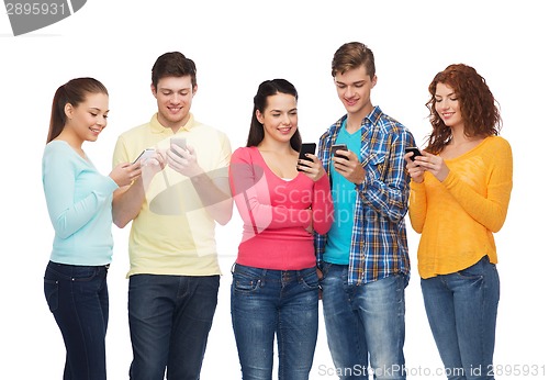 Image of group of smiling teenagers with smartphones