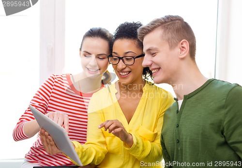 Image of smiling students with tablet pc at school