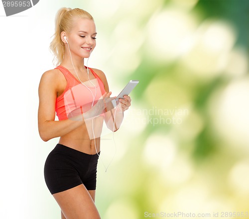Image of smiling sporty woman with smartphone and earphones
