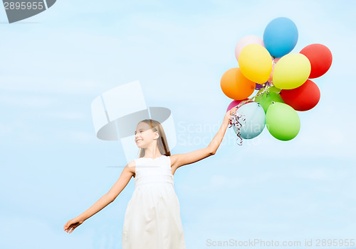 Image of happy girl with colorful balloons