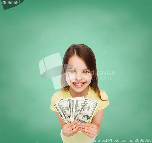 Image of smiling little girl with dollar cash money