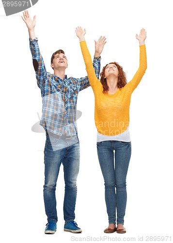 Image of smiling teenagers with raised hands