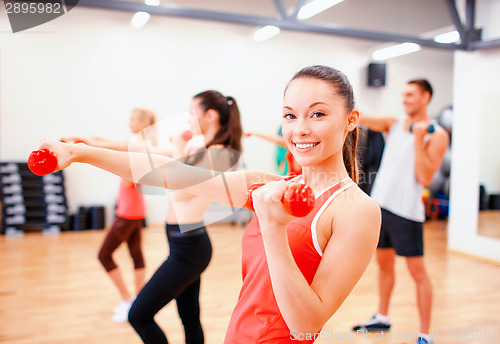 Image of group of people working out with dumbbells