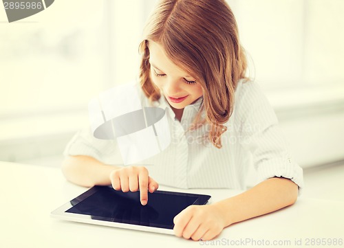 Image of smiling little girl with tablet pc at school