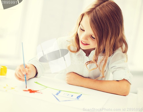 Image of little girl painting picture