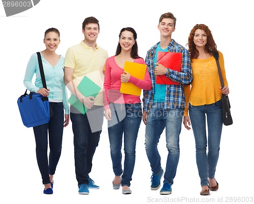 Image of group of smiling teenagers with folders and bags