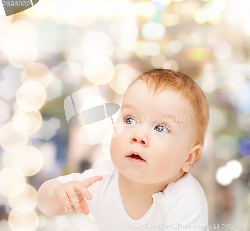 Image of curious baby looking side