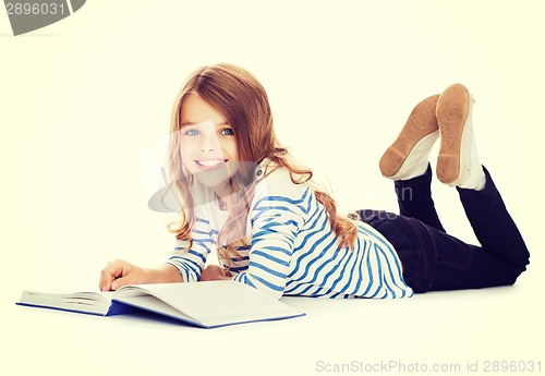 Image of smiling little student girl lying on the floor