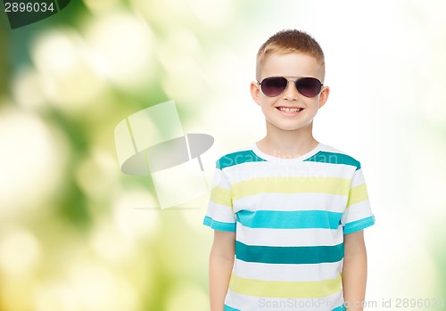 Image of smiling little boy over green background