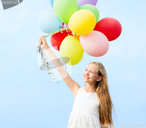 Image of happy girl with colorful balloons