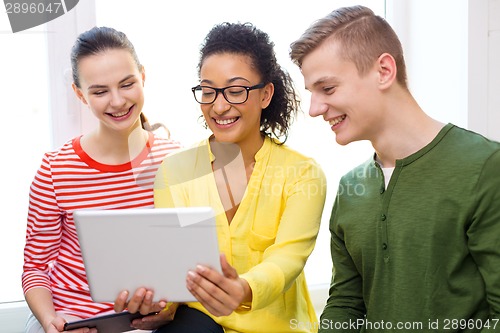 Image of smiling students with tablet pc at school