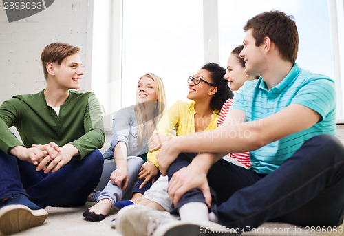 Image of five smiling teenagers having fun at home