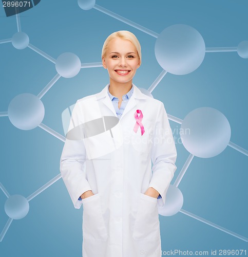 Image of smiling female doctor with cancer awareness ribbon