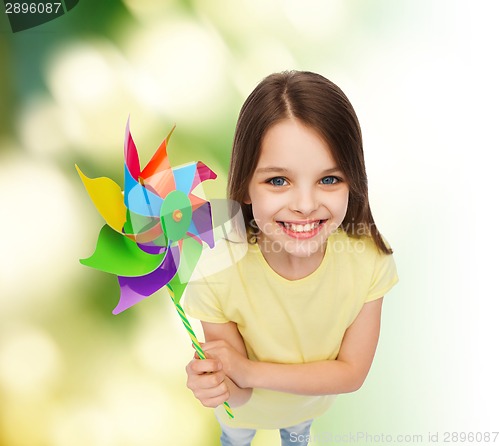 Image of smiling child with colorful windmill toy