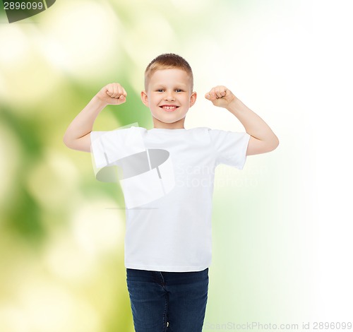 Image of little boy in white t-shirt with raised hands