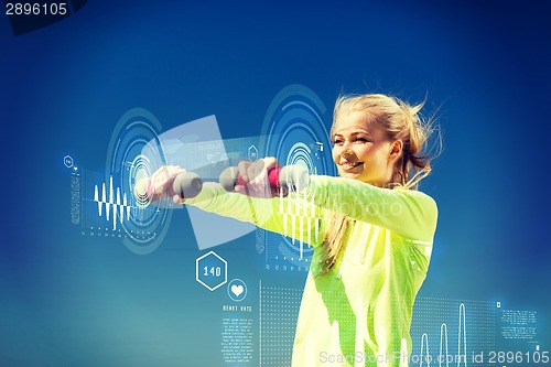 Image of sporty woman with light dumbbells outdoors